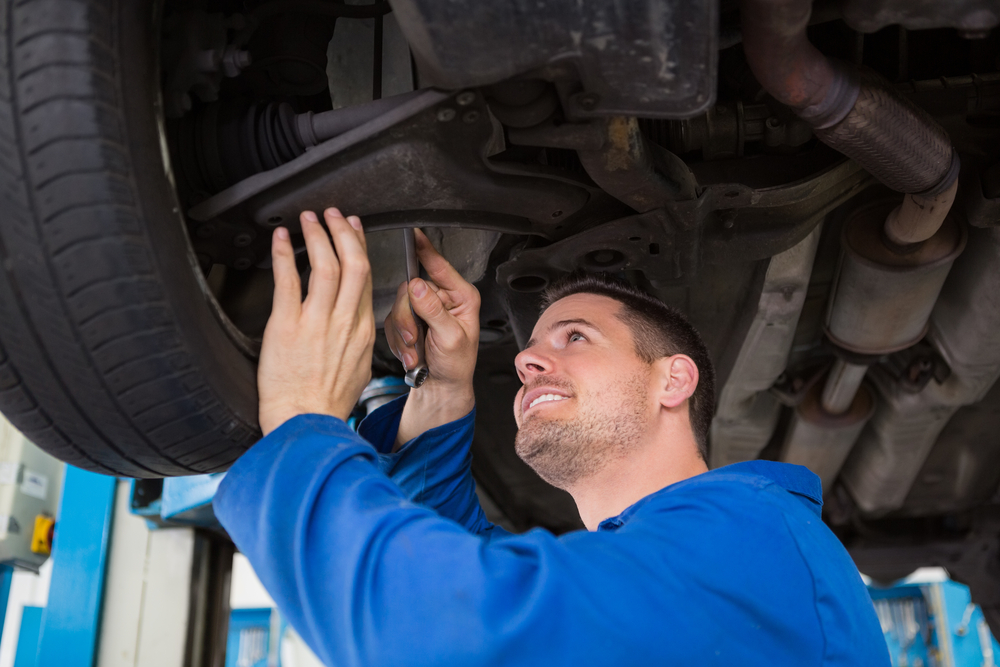 Mechanic adjusting the tire wheel at the repair garage